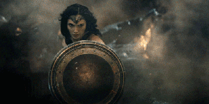 Gif of Wonder Woman in Batman V Superman featuring her jumping into battle with a shield and sword